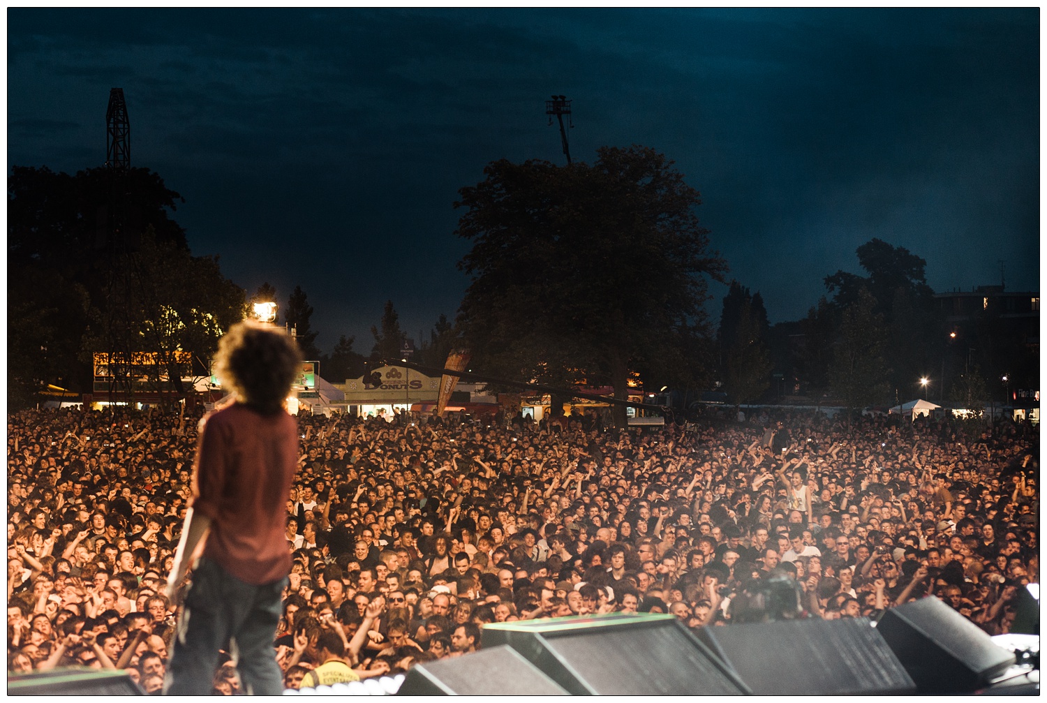 View of the crowd and Zack de la Rocha at Rage Against the Machine gig from the stage at Finsbury Park.