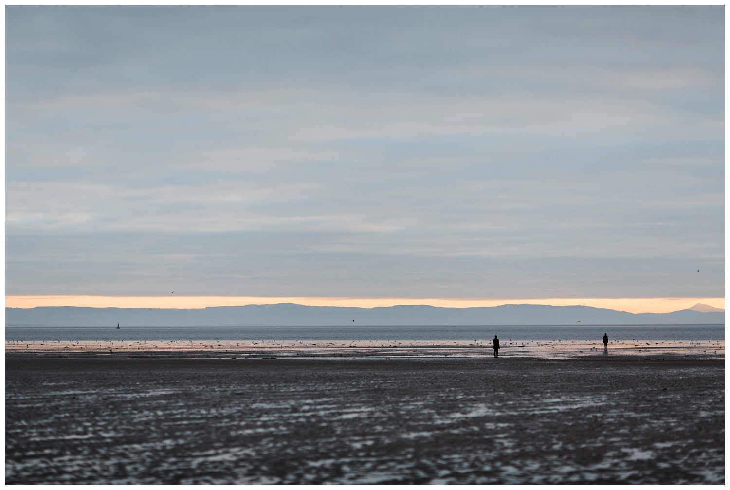 Antony Gormley Another Place sculptures on Crosby beach near Liverpool