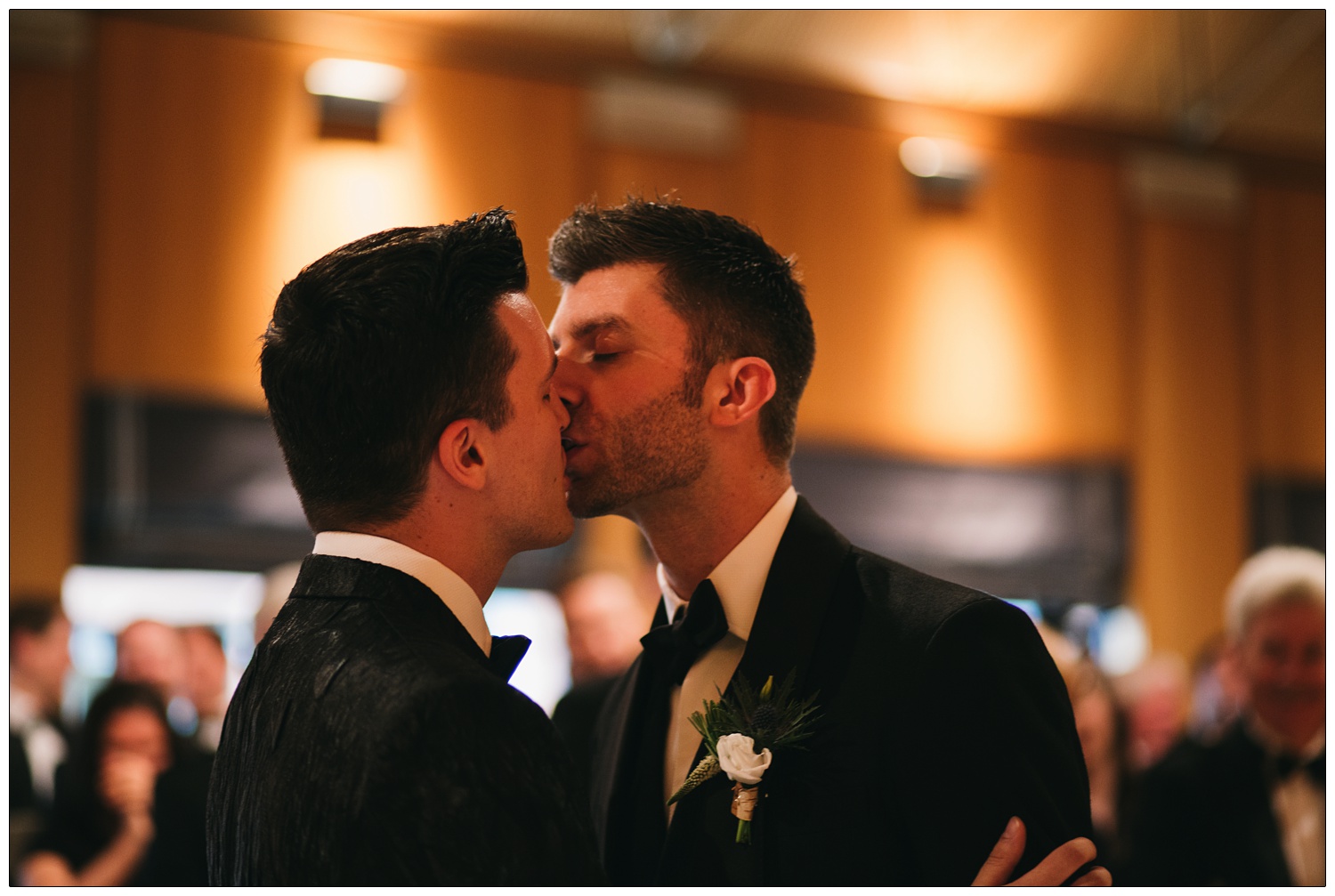 Two men kiss during a civil partnership ceremony.