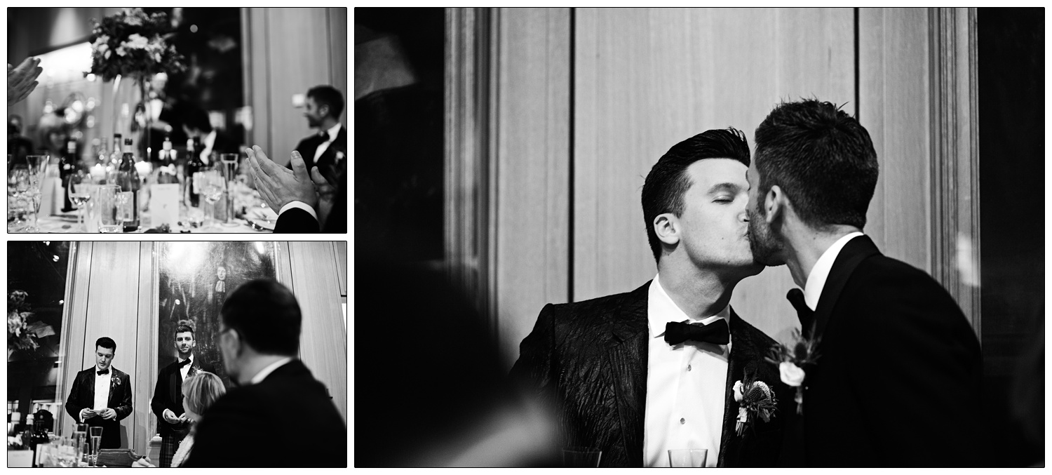 The two grooms kiss during speeches.
