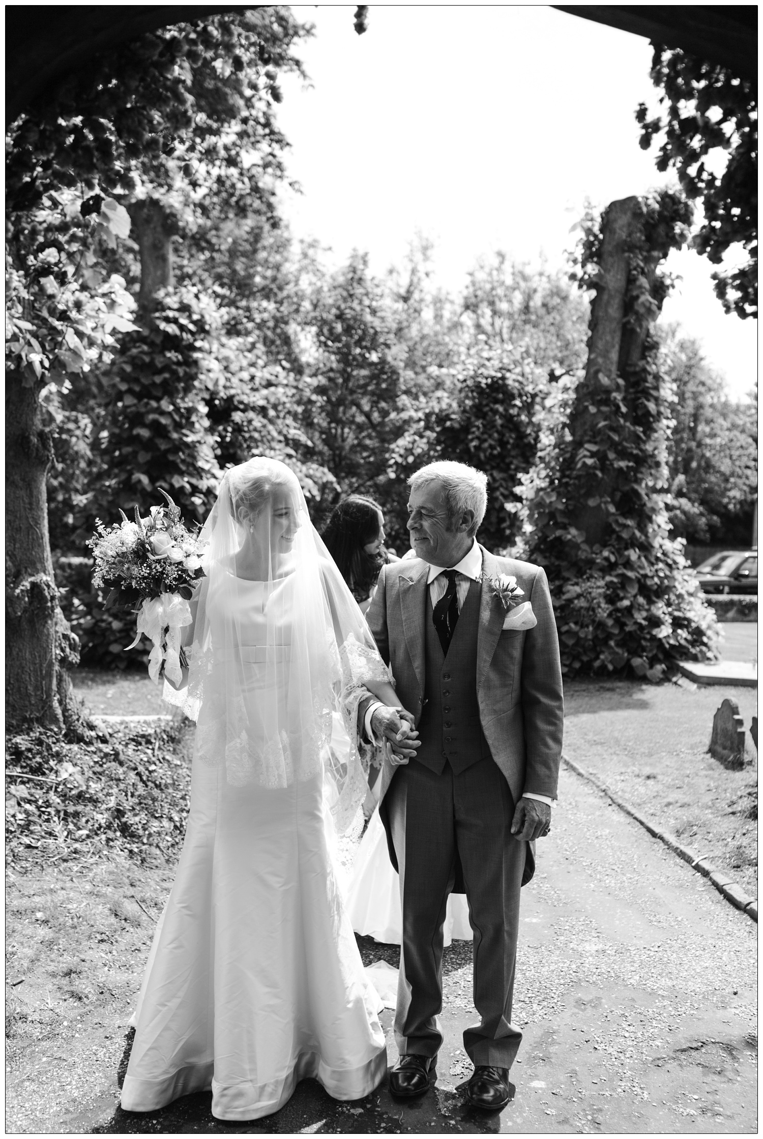 Bride and her father looking at each other before entering the church in Bradwell-on-Sea.