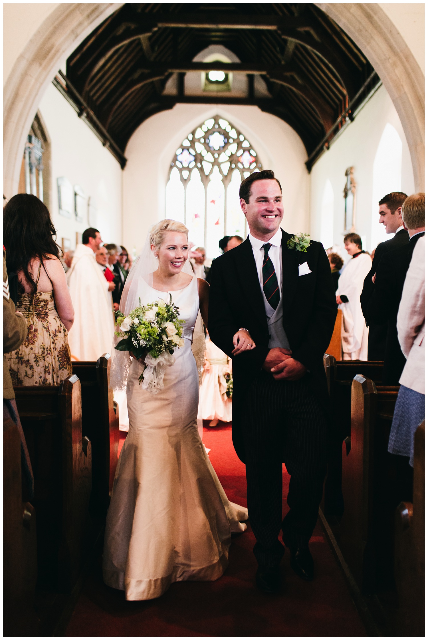 Bride & groom walking down the aisle at St Thomas’ church in Bradwell-on-Sea.