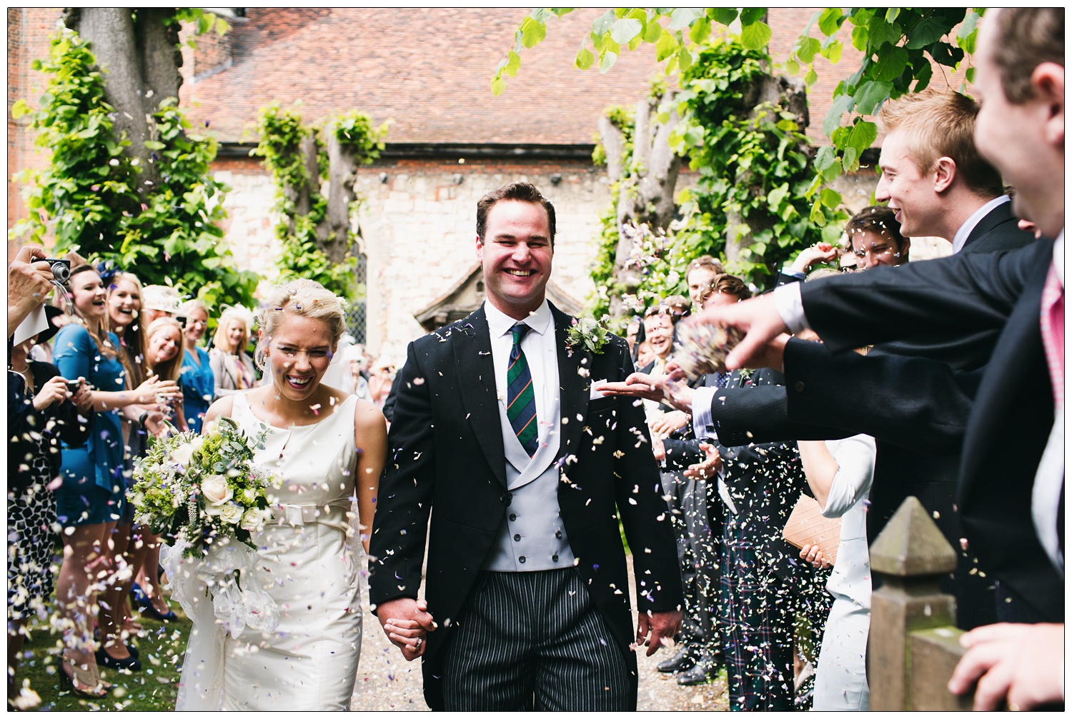 People throw confetti and a newly married couple leaving St Thomas’ church in Bradwell-on-Sea