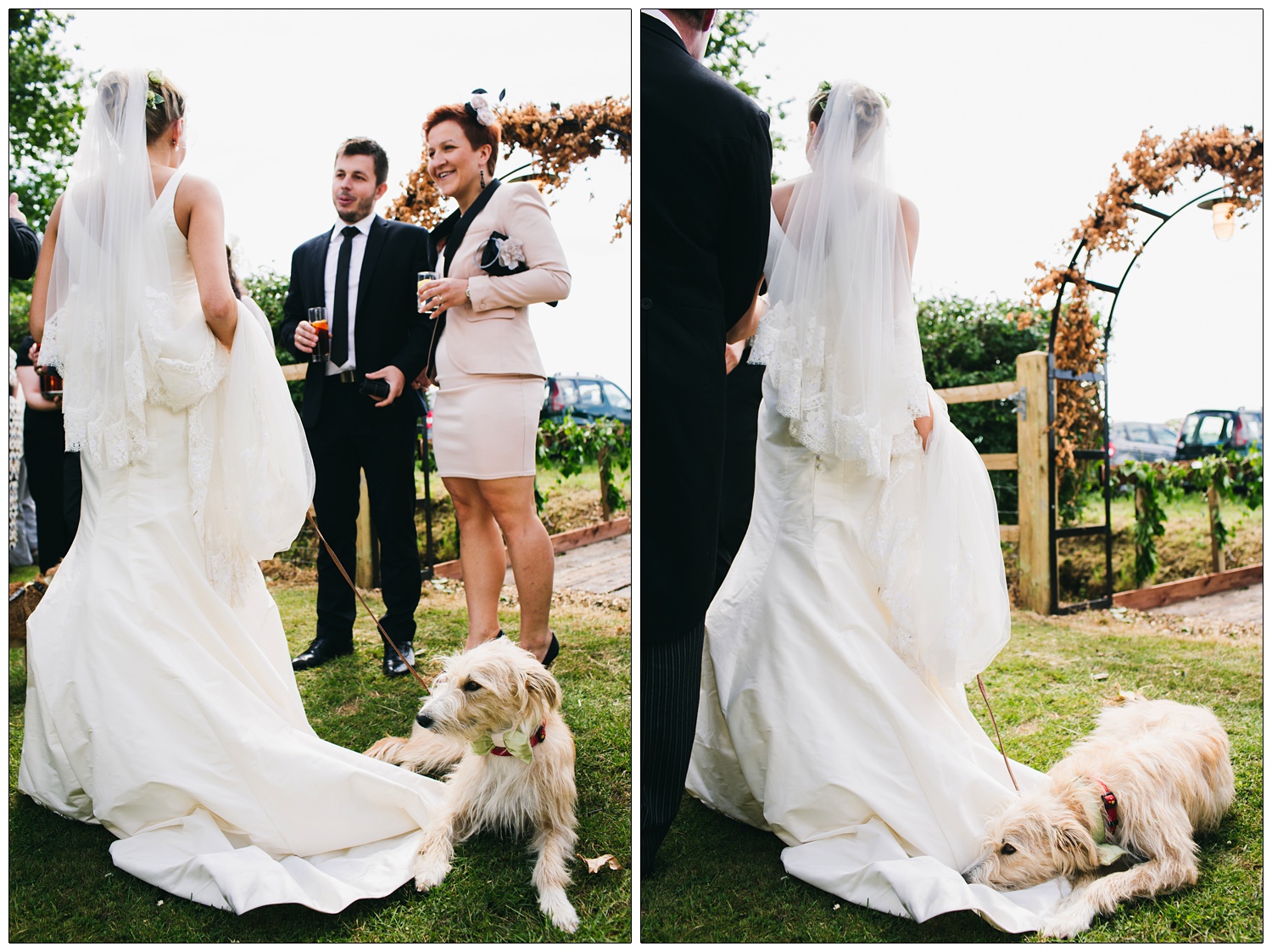 A bride is talking to wedding guests in a garden, her dog is laying on the bottom of her dress.