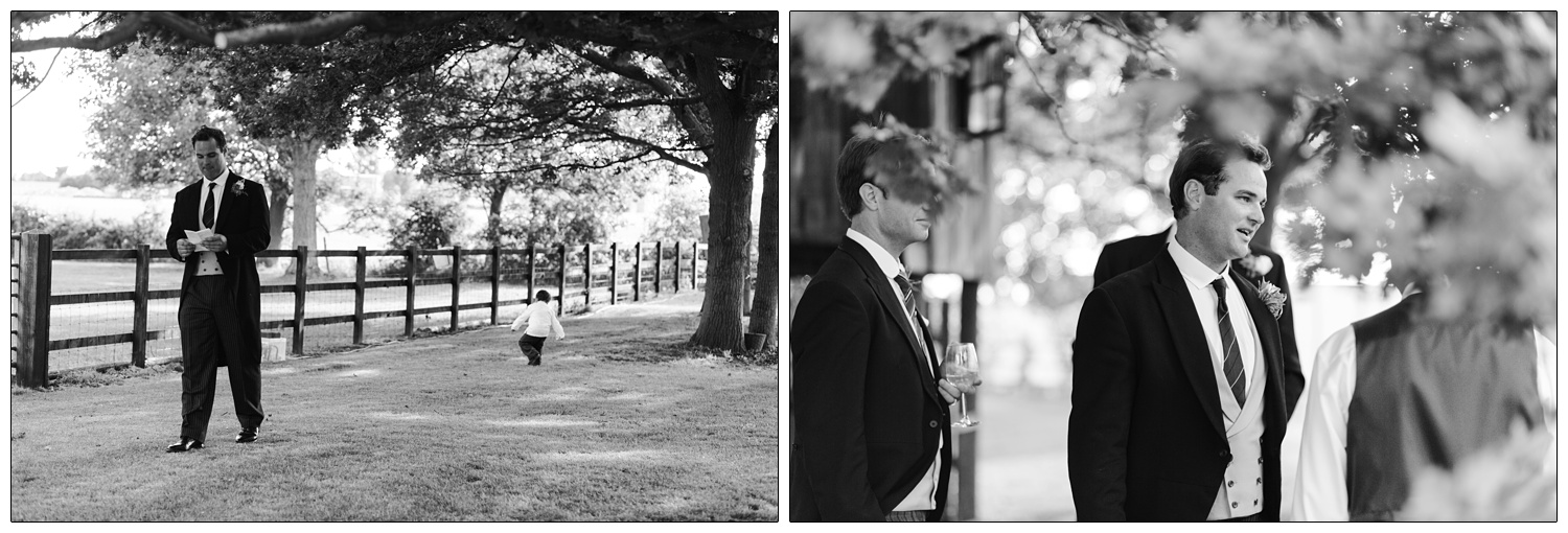 Groom is walking outside, nervously checking his speech. A boy is playing by a tree. Reportage style photo.