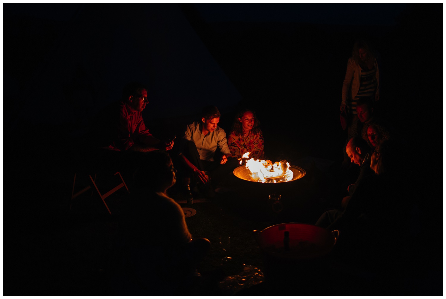 People sat around a fire pit.