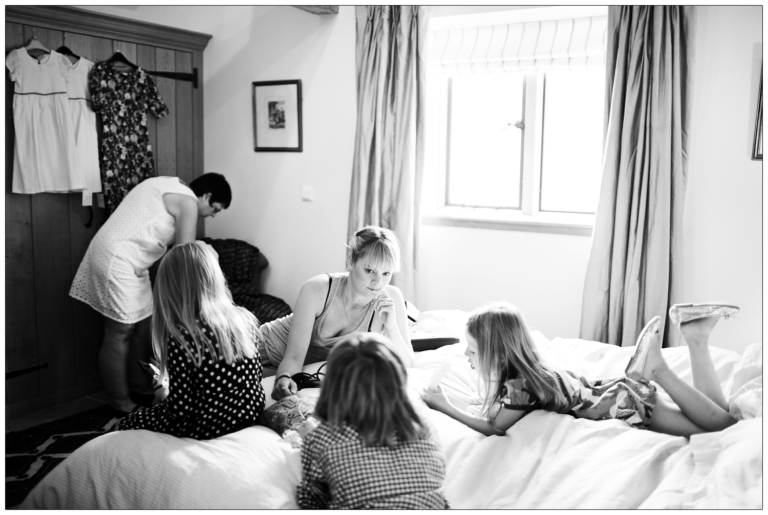 Women and girls in a bedroom before a wedding.