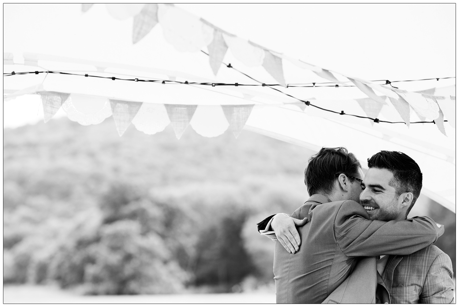 The groom hugs his friend.