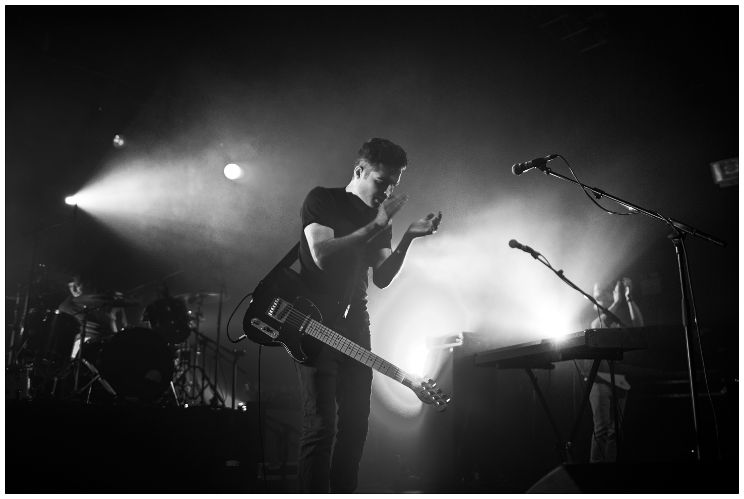 Black and white photograph of Nathan Nicholson clapping at The Boxer Rebellion gig at The Forum in 2013