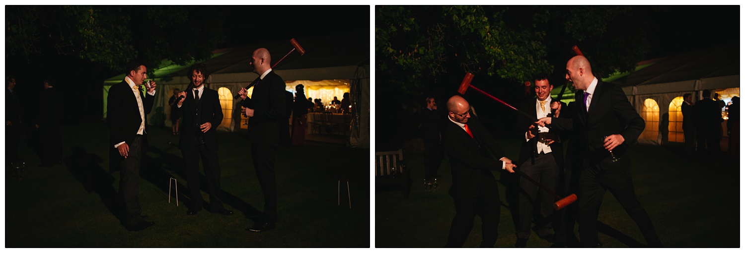 Men mucking around with croquet mallets at night, outside a marquee.