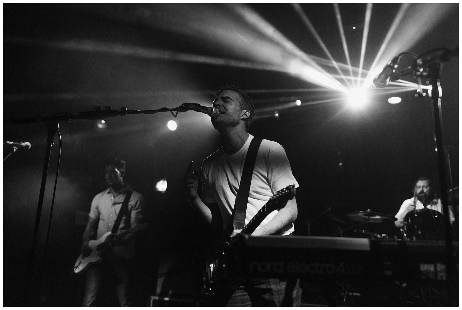 Black and white photograph of Nathan Nicholson, guitarist Andrew Smith, and Piers Hewitt performing in The Boxer Rebellion at the Scala in 2014