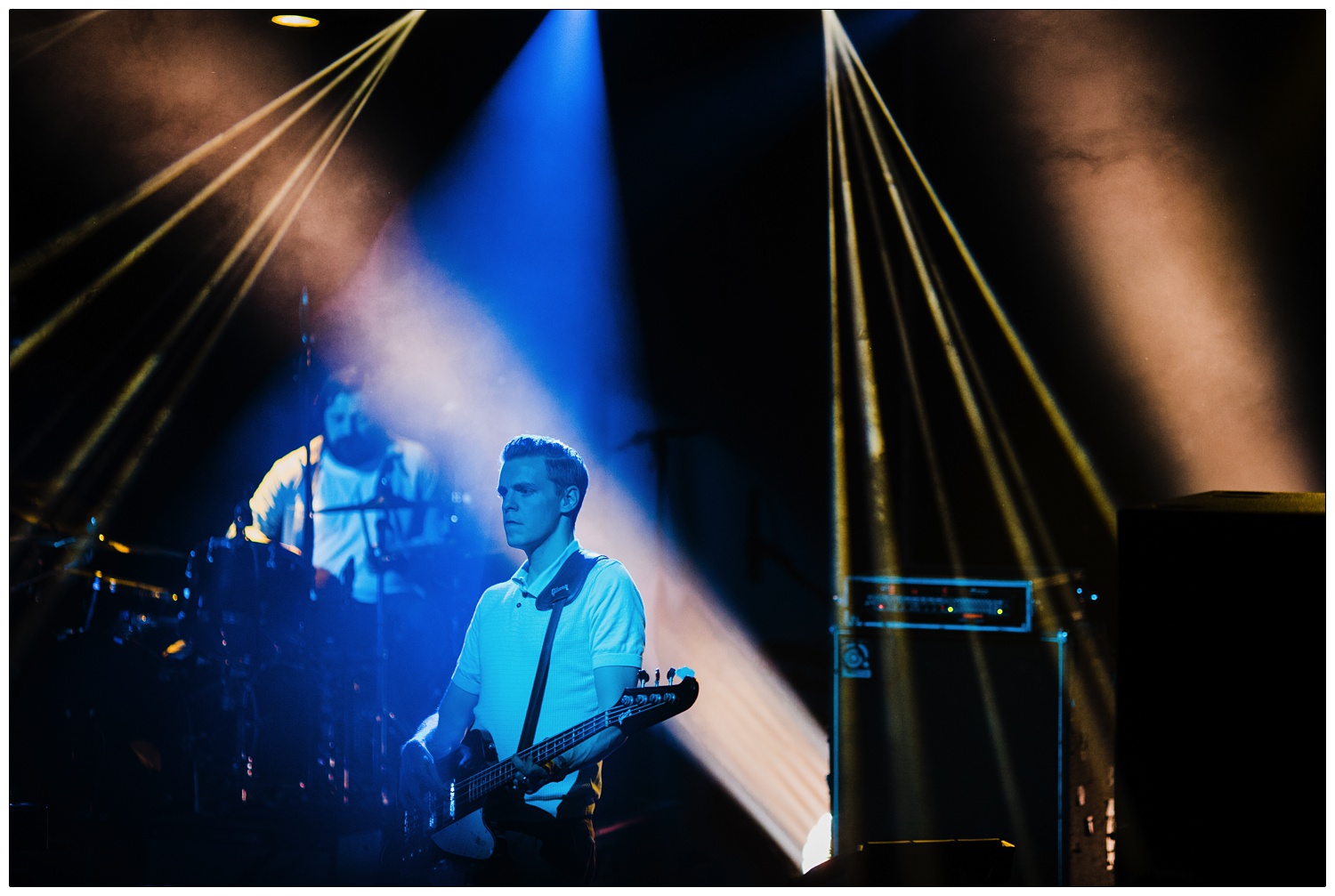 Adam Harrison playing bass and Piers Hewitt on drums in blue lights at The Boxer Rebellion gig in 2014