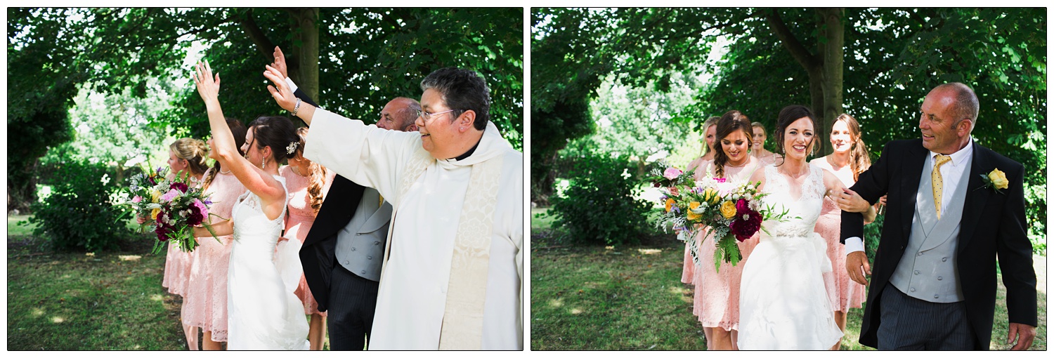 Bridal party and vicar are waving.