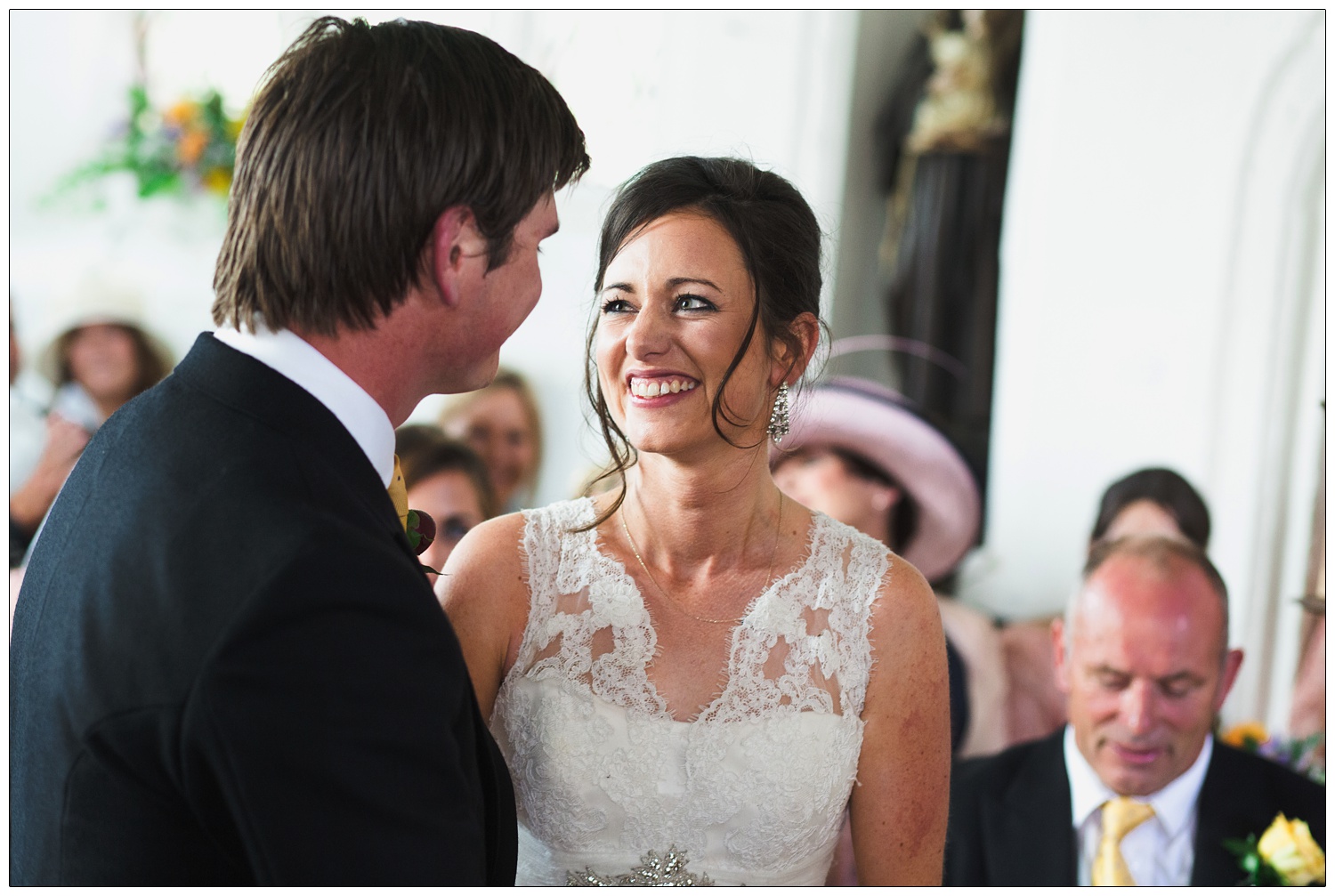 The bride smiles at her husband at the end of the wedding.