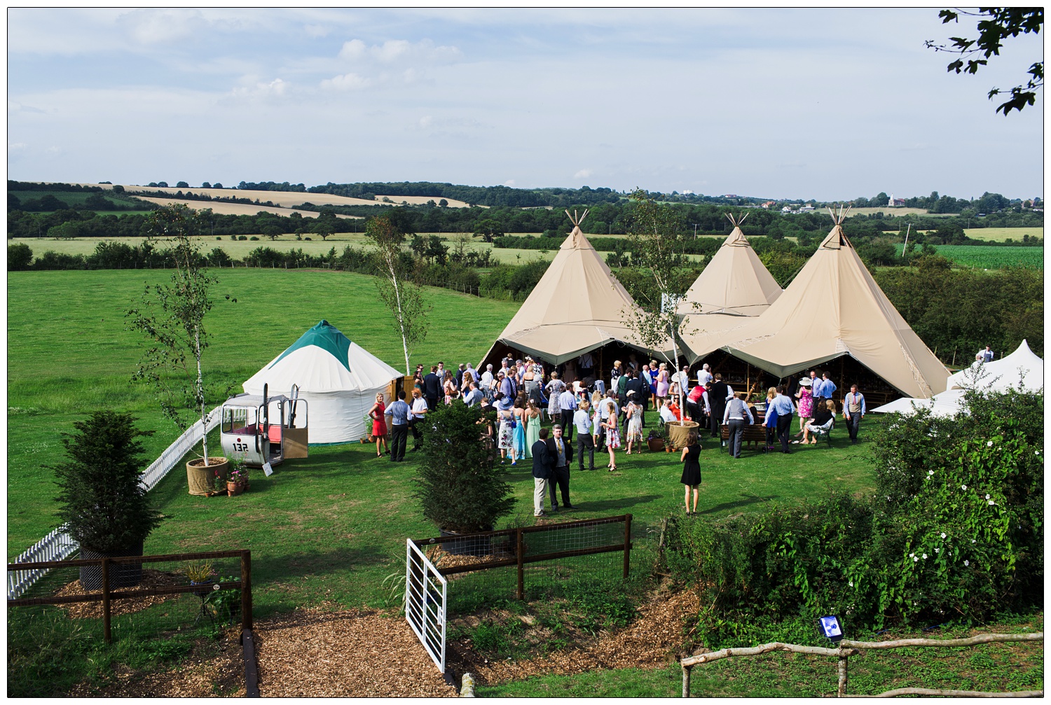 A view of a wedding Tentipi in a field, with the Essex countryside of Stow Maries in view.