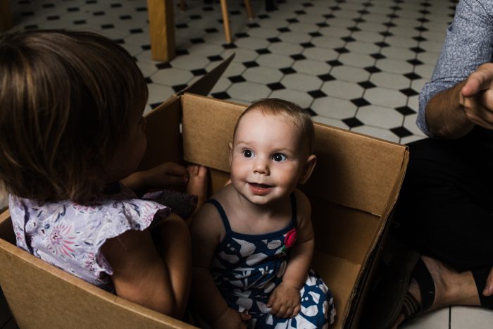 lifestyle family photography style portrait of a baby in a box