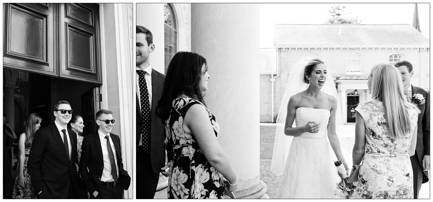 Bride laughs when greeting friends at Brentwood Cathedral after her wedding.
