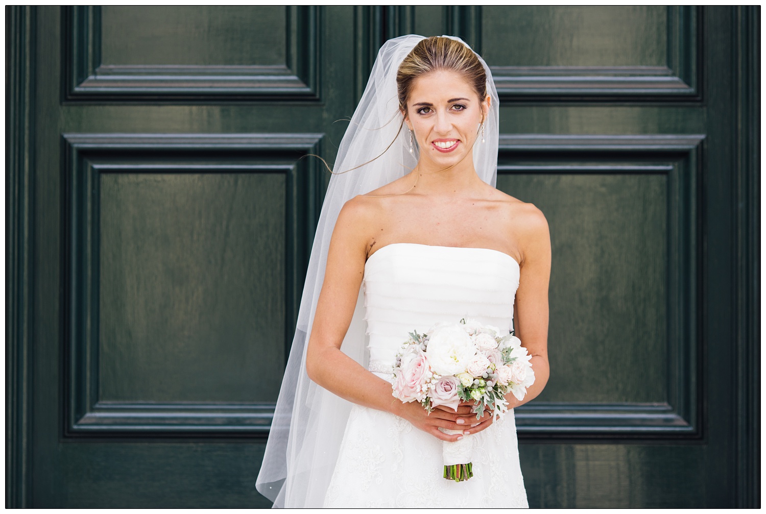 Bride in front of the door at Brentwood Cathedral.