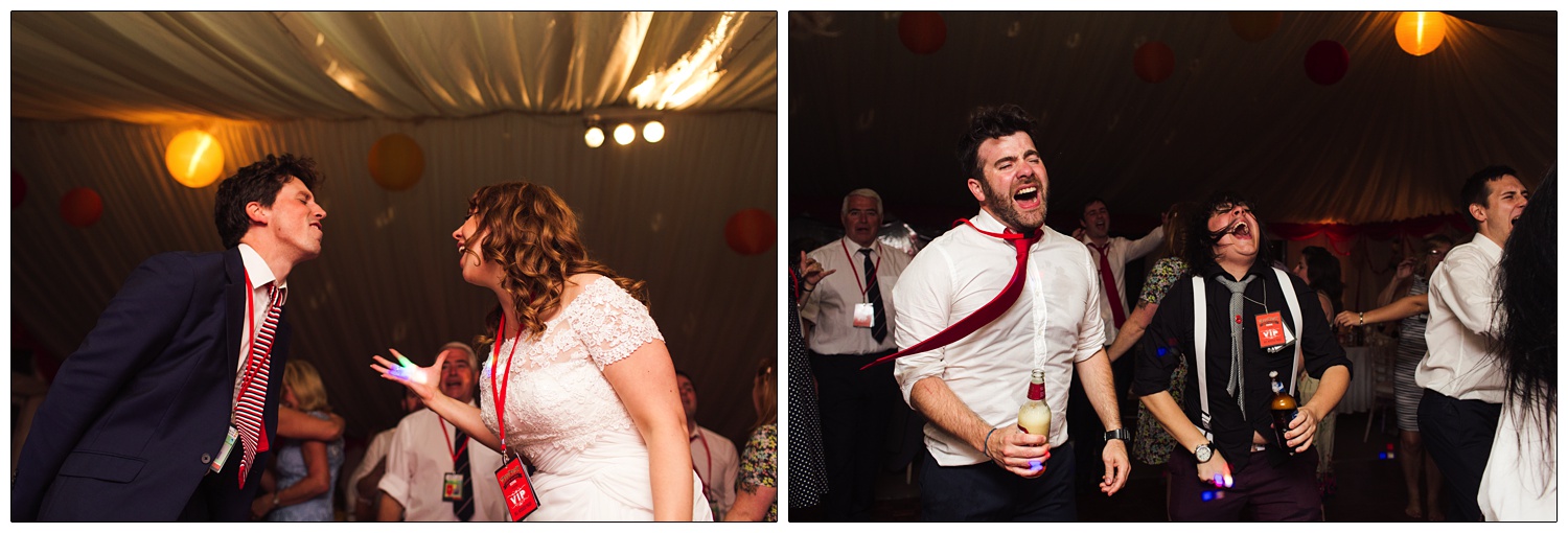 Wedding reception dancing at a festival themed wedding. They are wearing lanyards. The bride is singing at a guest.