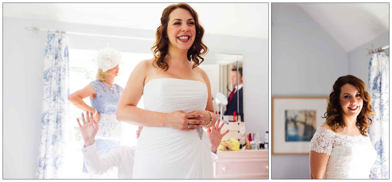 In her bedroom a bride smiles in her wedding dress.