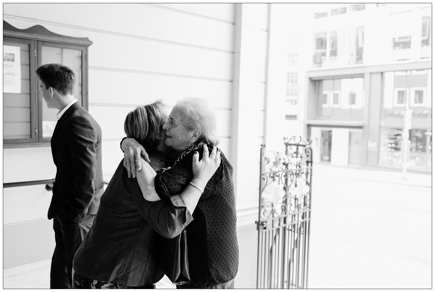 People hugging each other before entering a church.