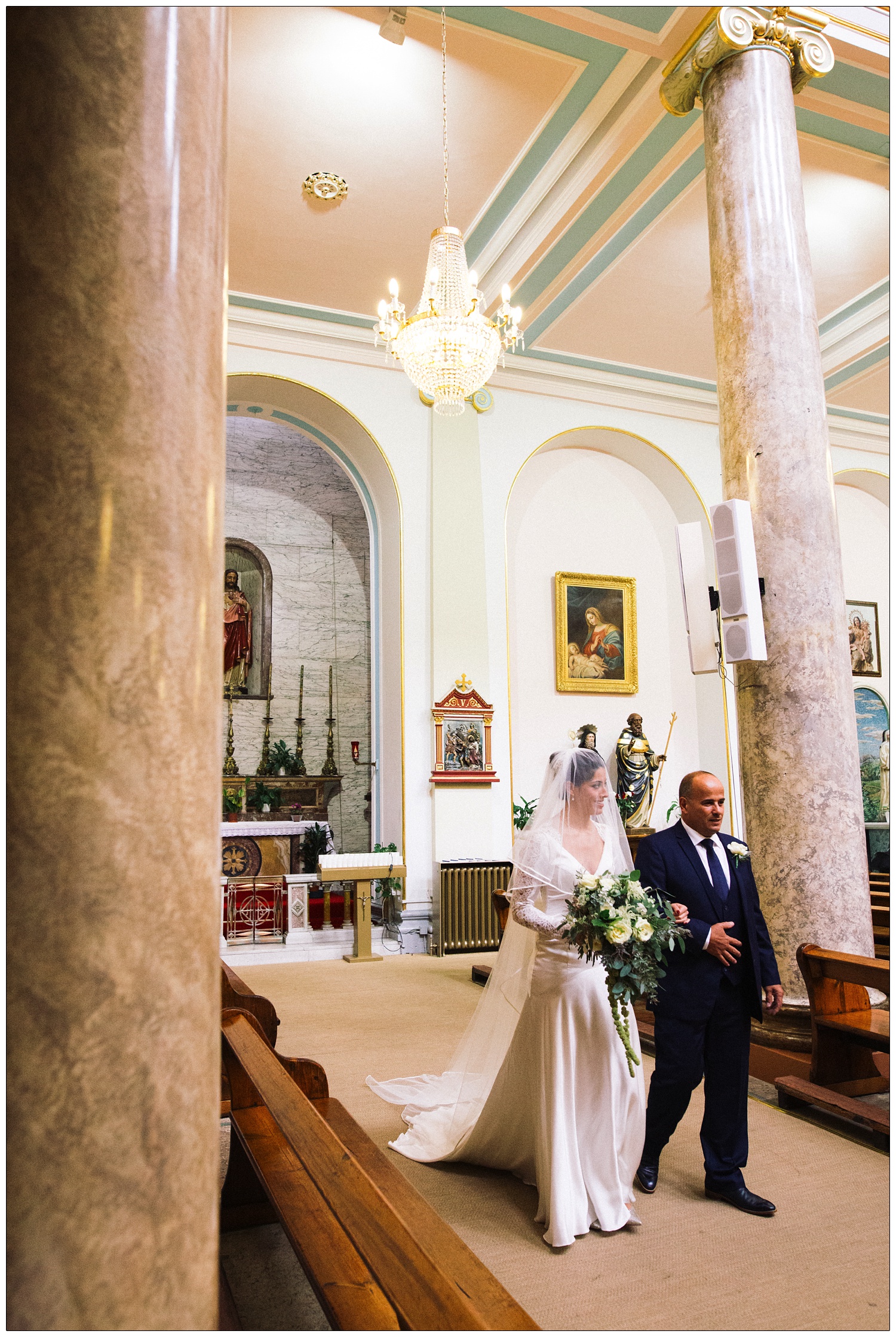 Bride and her father entering the St. Peter's Italian Church in Clerkenwell.