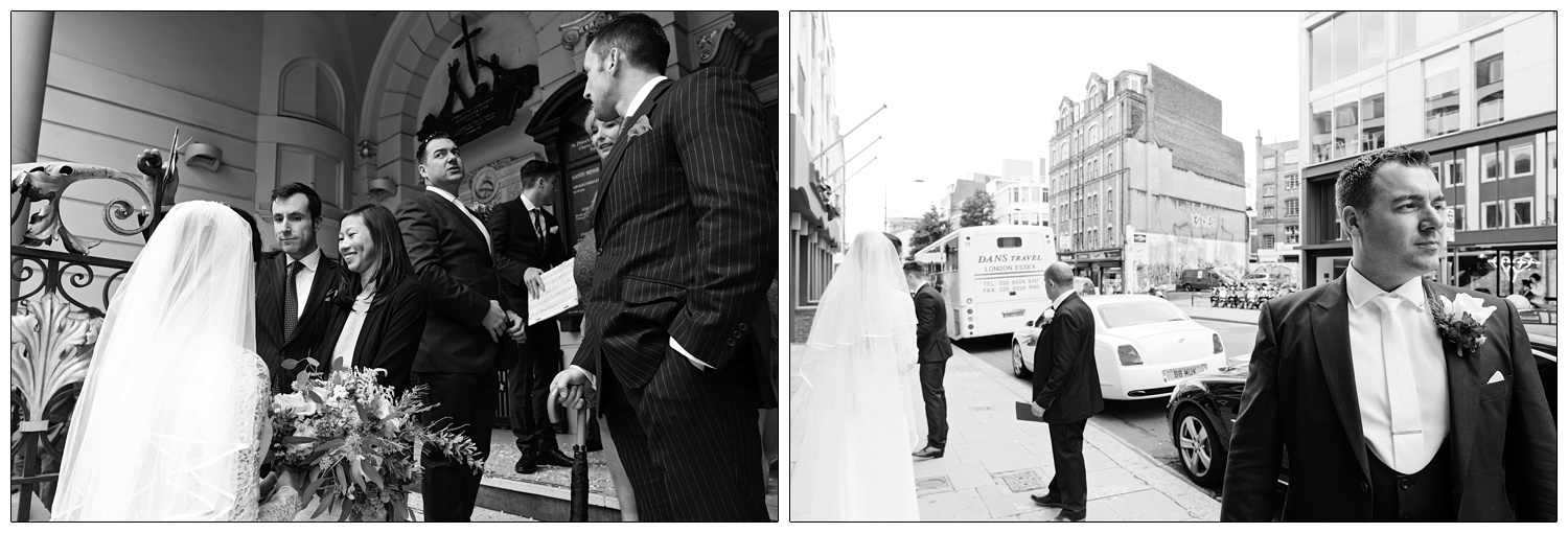 A man after his wedding stands on Clerkenwell Road outside St. Peter's Italian Church. His wife is in the background.