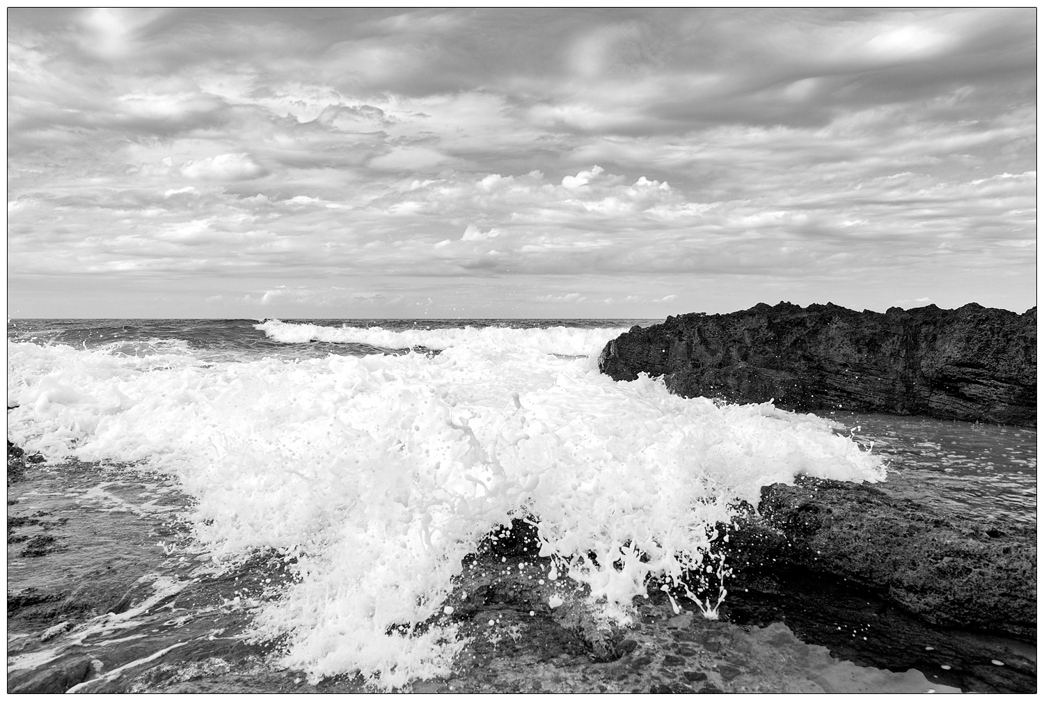 Black and white photograph of the frothy waves in Santa Maria di Castellabate