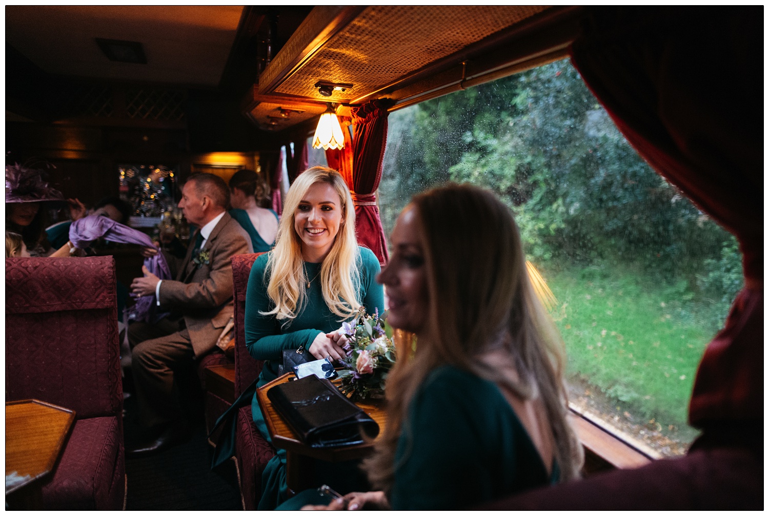 Bridesmaids and family are set on a coach. It is raining outside.