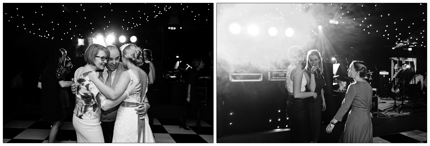 Mum, dad and the bride have a hug on the dance floor.