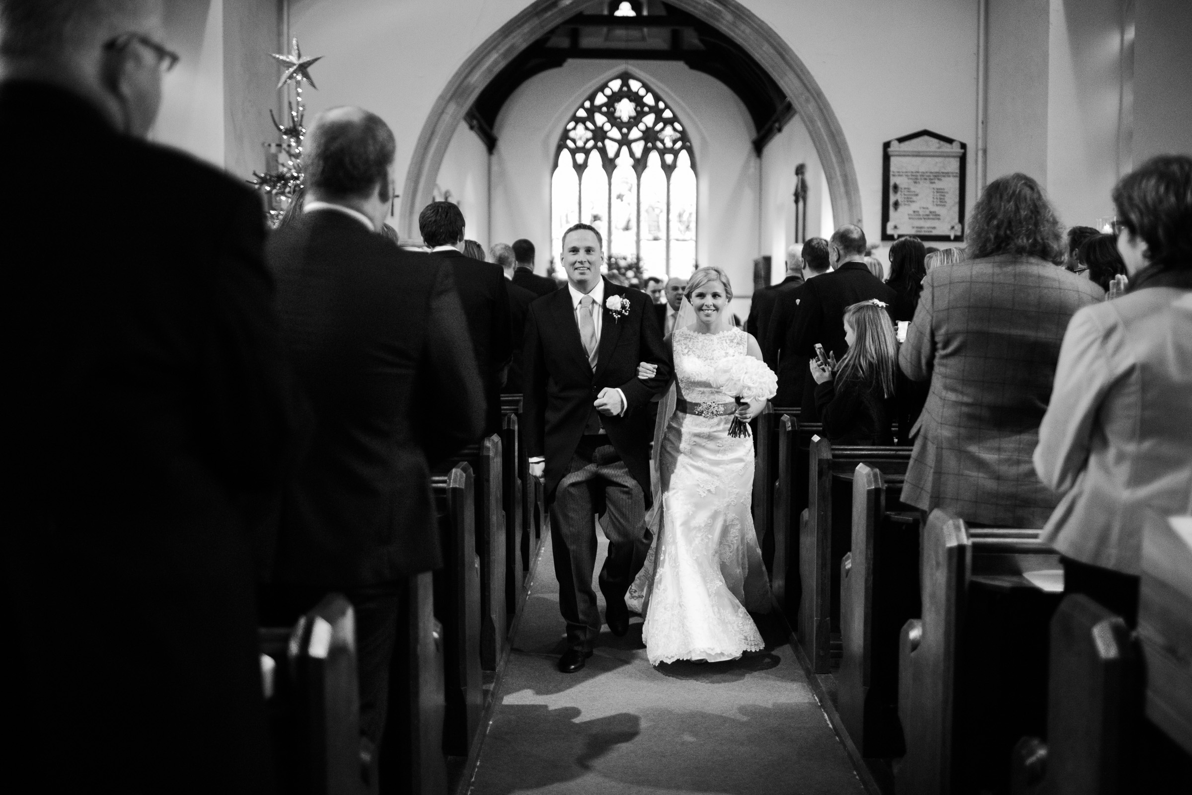 The new wife and husband walk down the aisle of St Thomas' Church Bradwell-on-Sea.