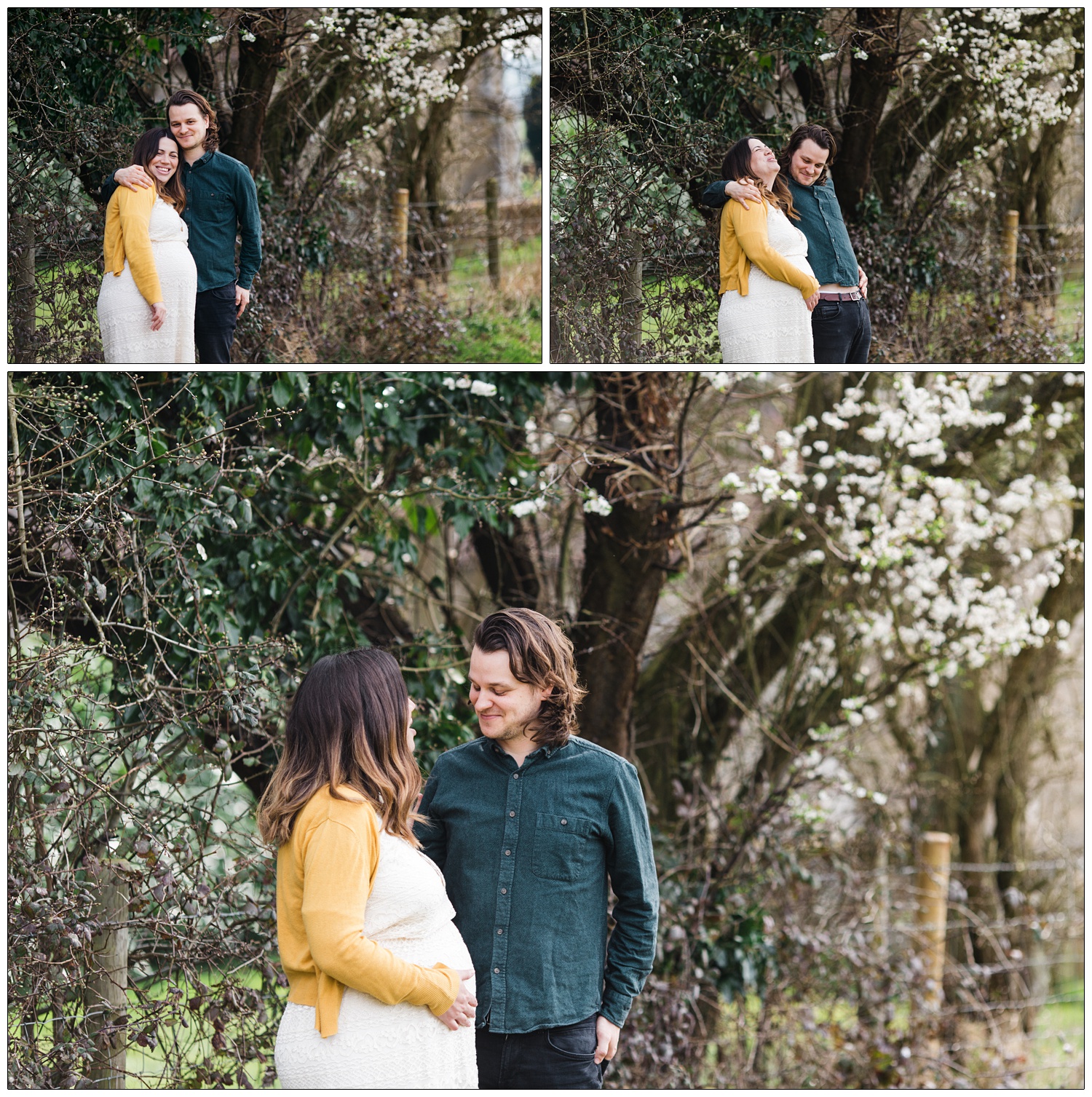 Pregnant woman and her husband in a field, there is blossom on the trees
