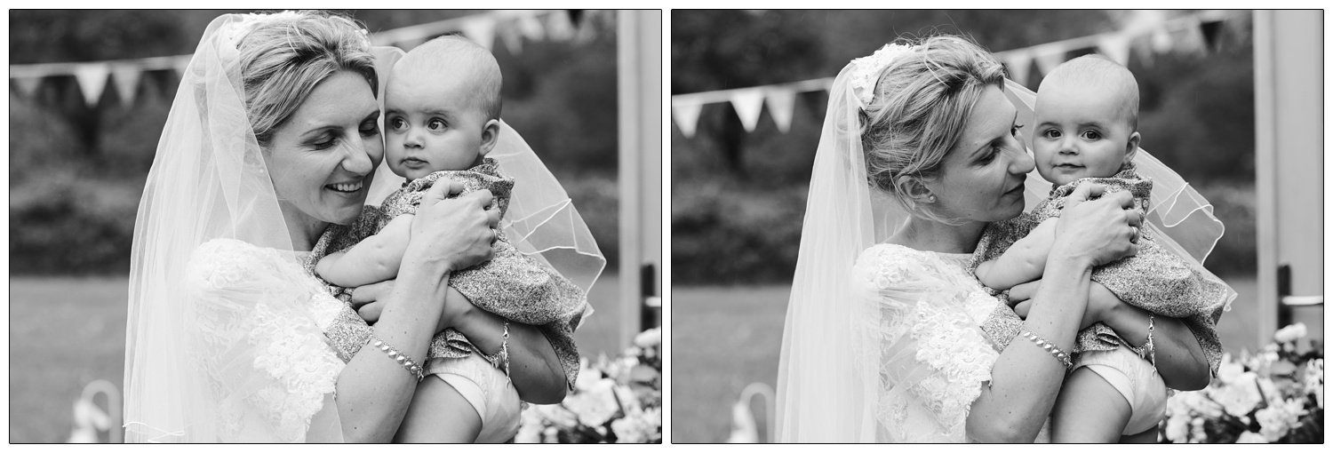 black and white photo of bride with baby