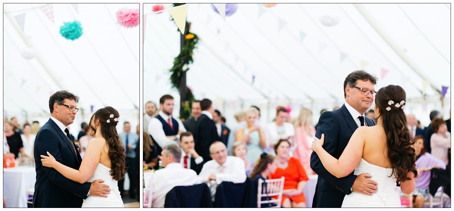 bride dancing with her dad in a marquee with bunting