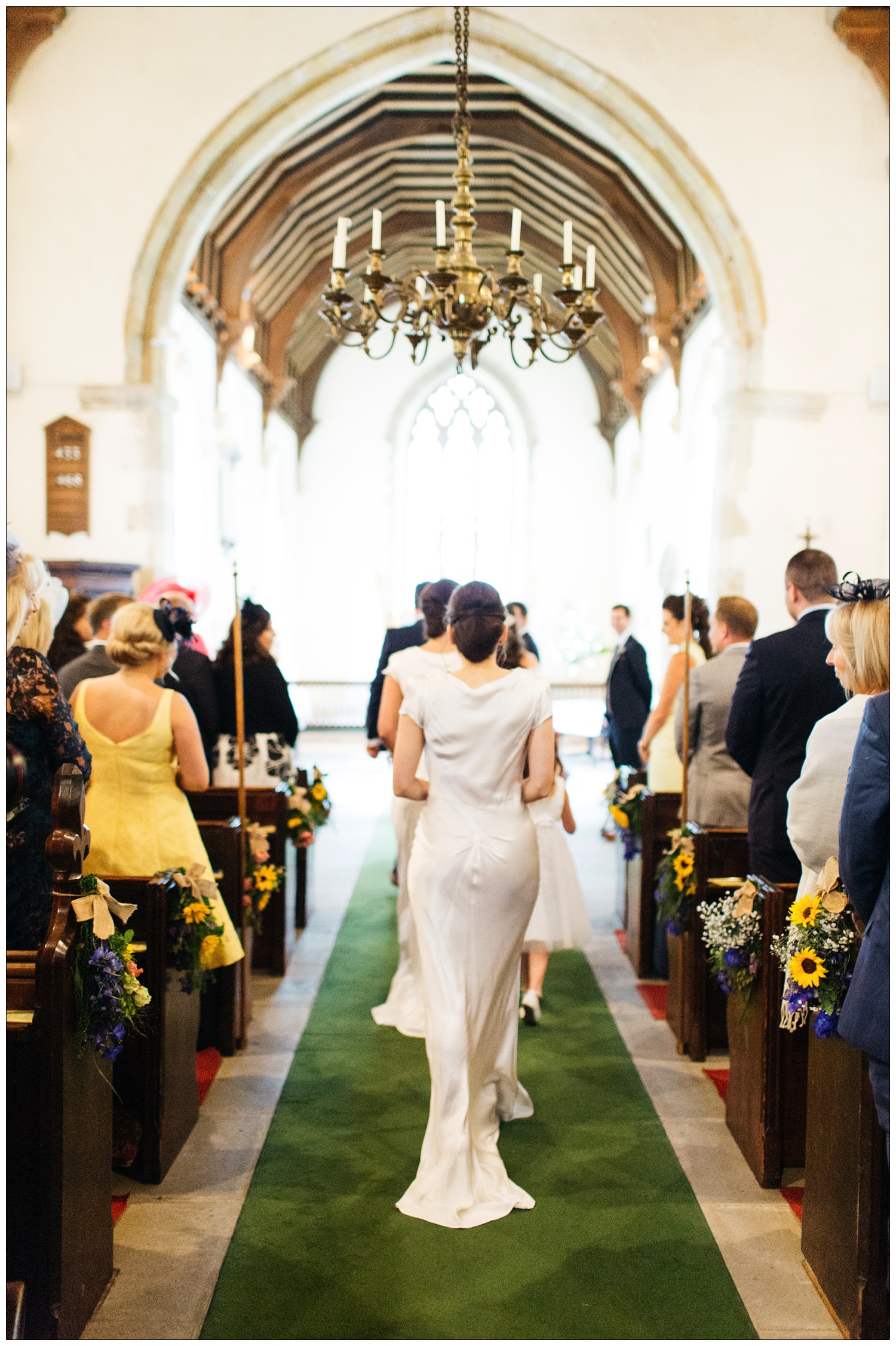 bridesmaids walking up the aisle All Saints church in Purleigh