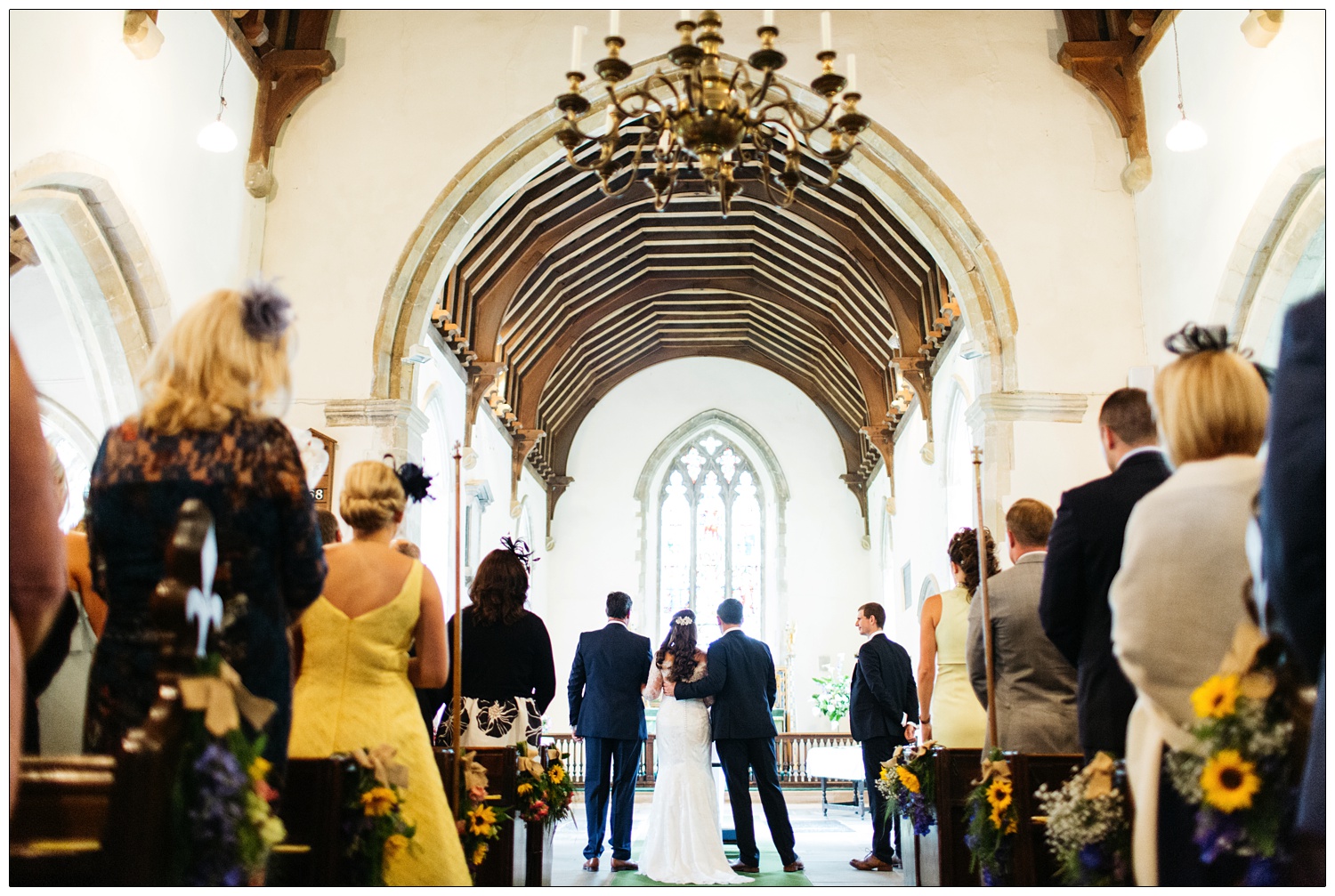 All Saints church in Purleigh groom has his arm behind his new wife's back