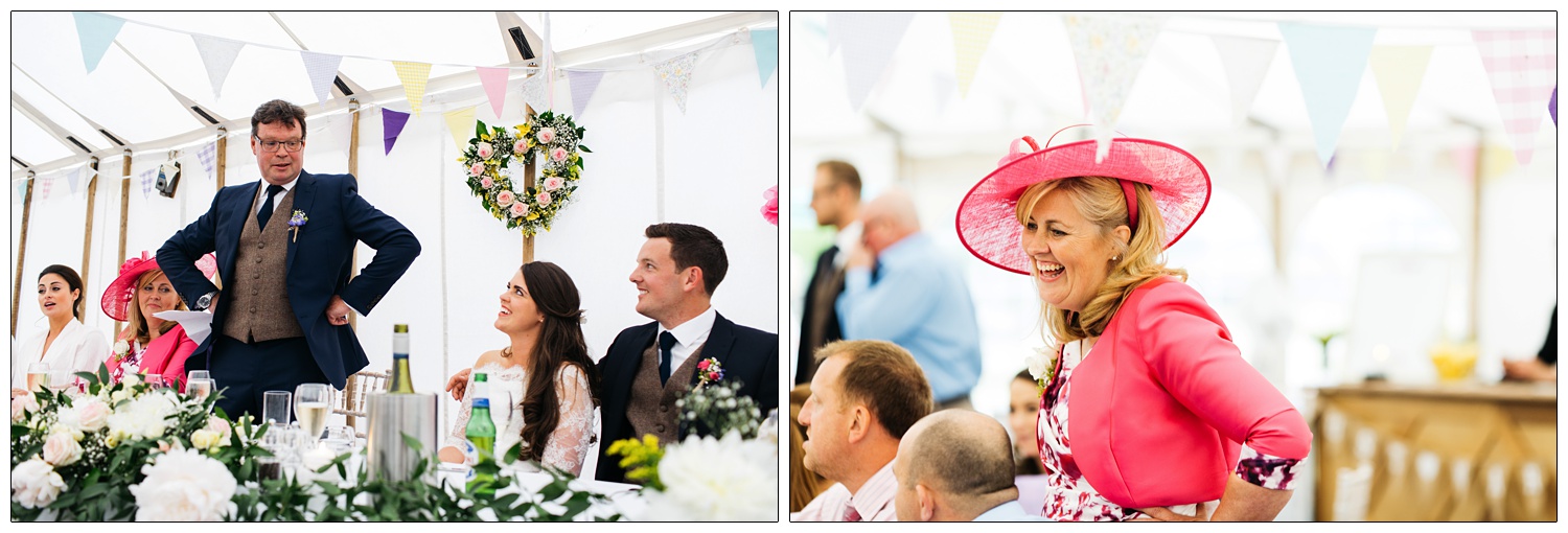 Bride's father standing at the top table looking at his daughter who is sitting down.