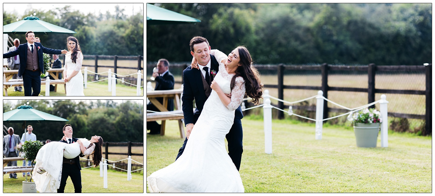 newly married couple mucking around outside in the sun, new husband picking up his wife