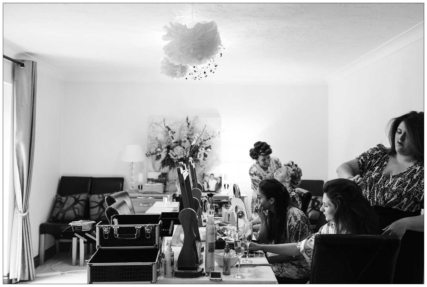bride and bridesmaids getting ready in a dining room