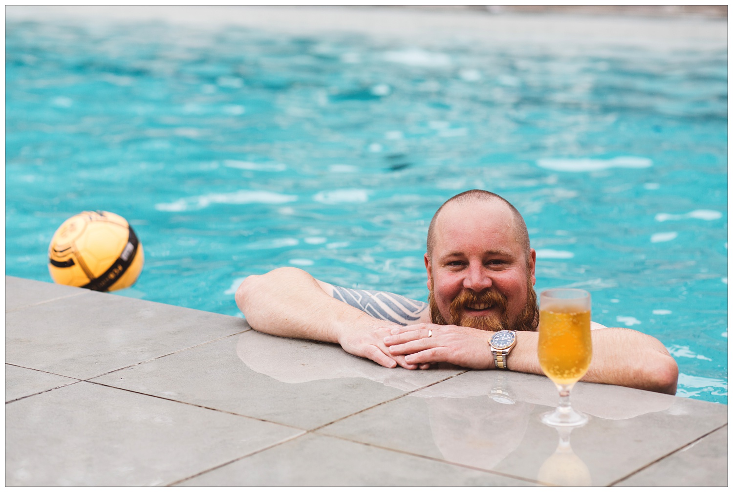 groom with a beer in the pool at Maison Talbooth