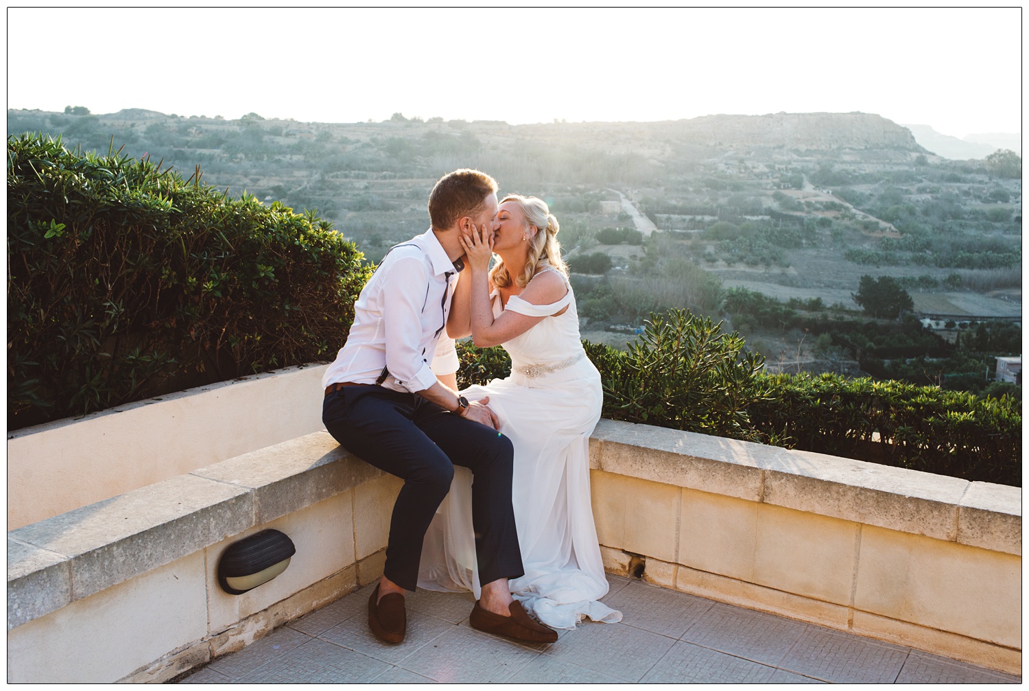 bride and groom kissing at the Cornucopia Hotel in Gozo after getting married