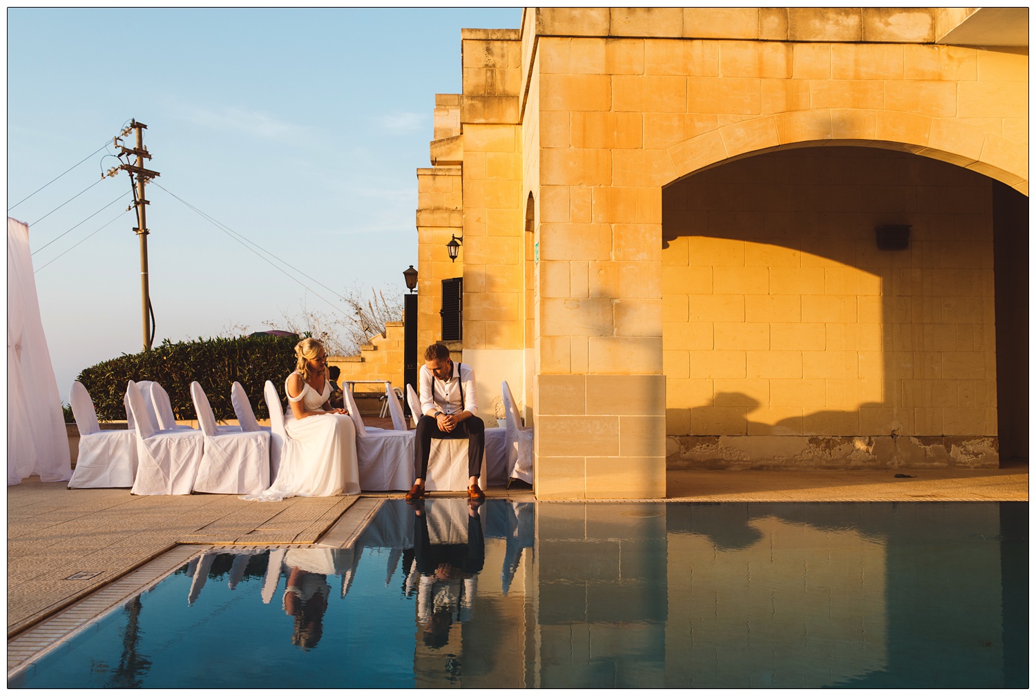 bride and groom after the ceremony sitting around the pool at The Cornucopia Hotel