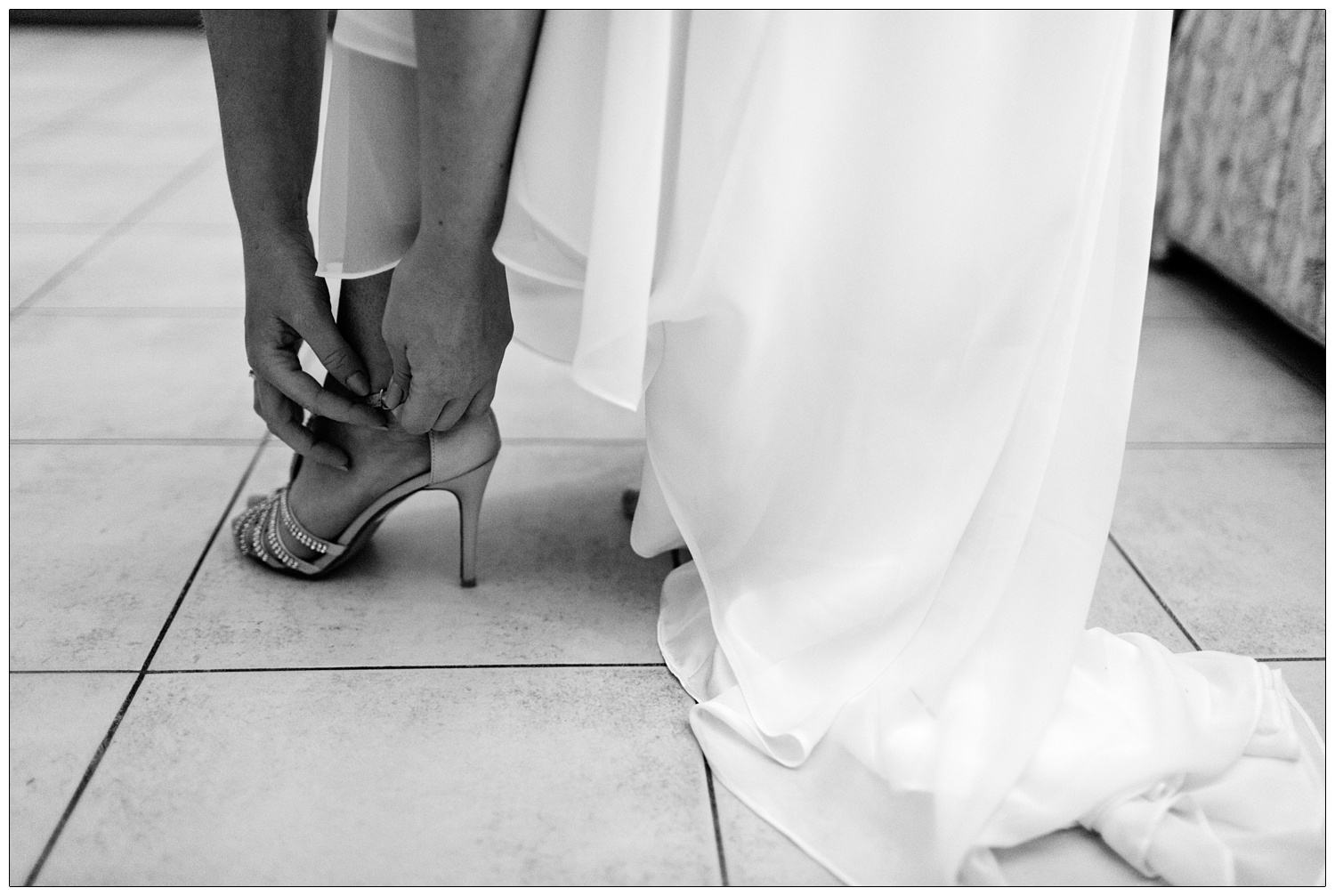 bride doing up her shoe