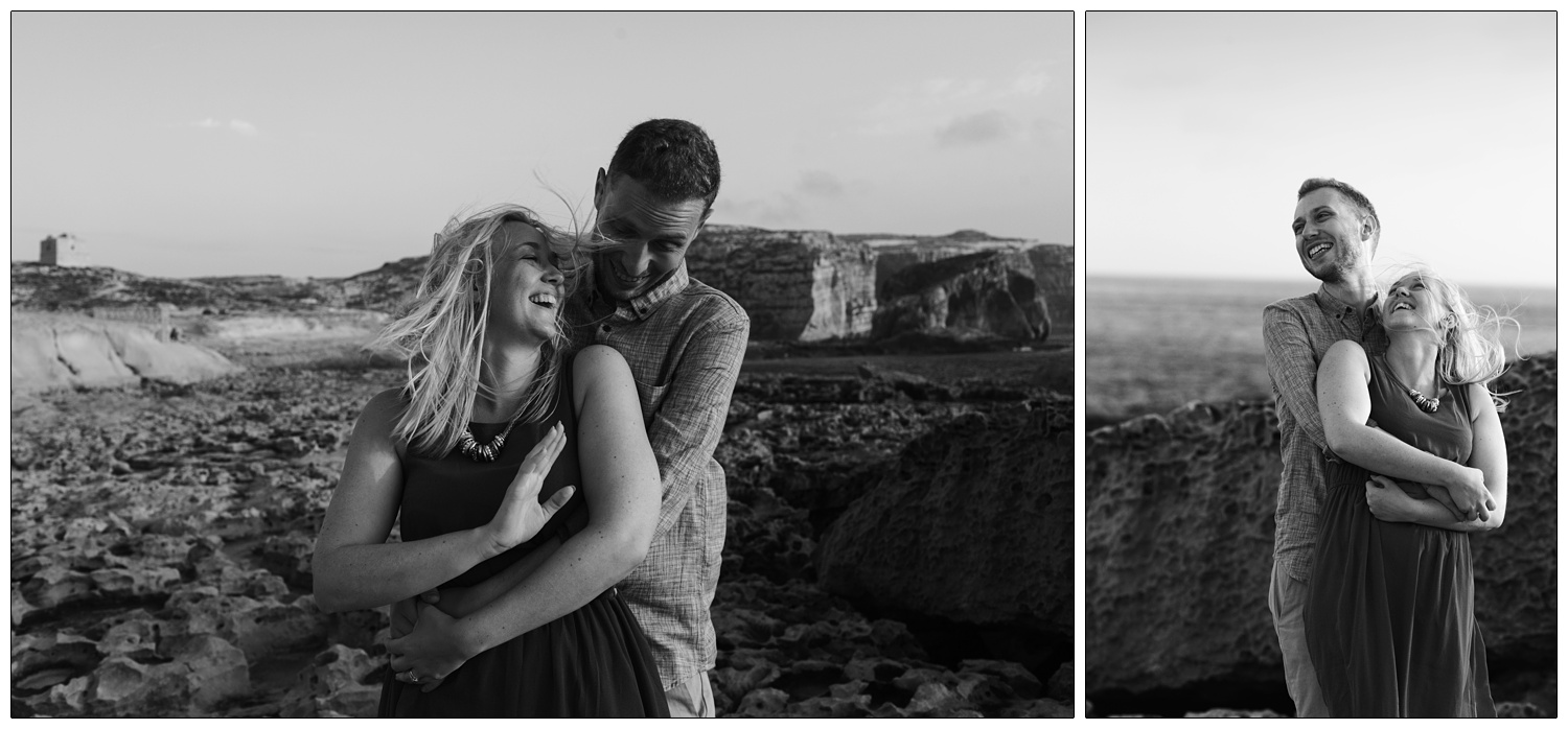 black and white photographs of new husband and wife hugging and laughing on a windy coast in Gozo near Dwejra bay
