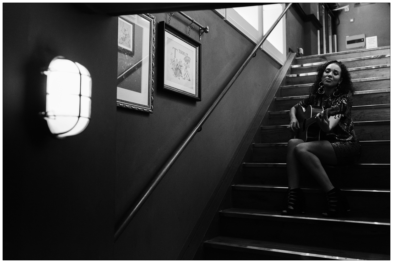 Malaika performing for Disorder magazine on the stairs of a pub
