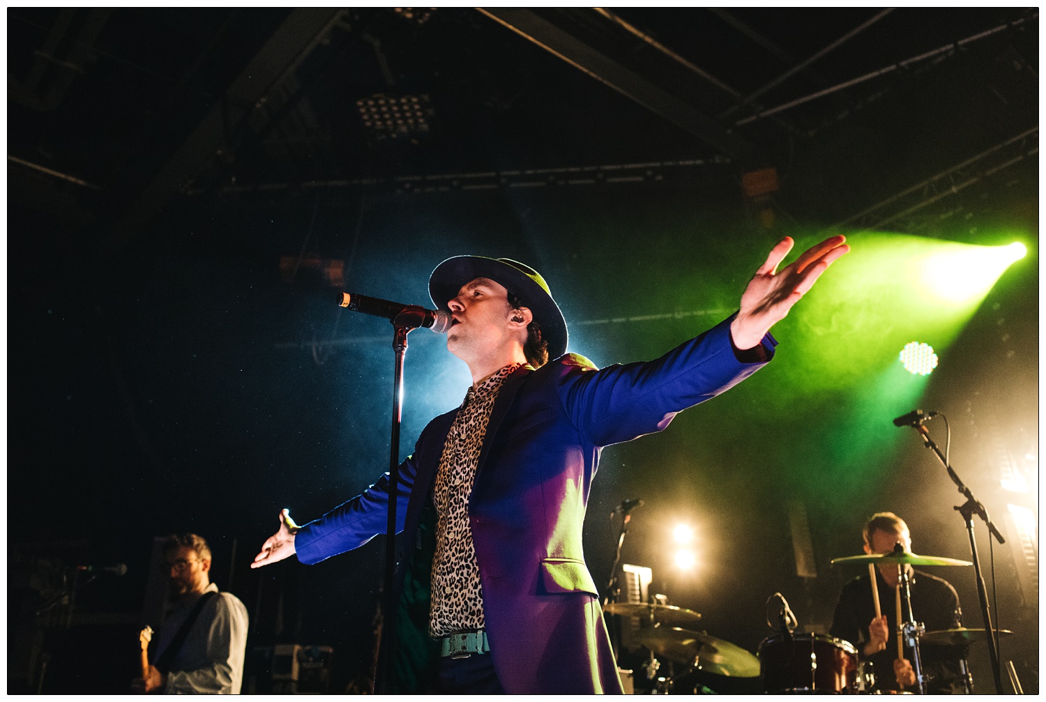 Paul Smith with open arms singing, Duncan Lloyd on guitar and Tom English on drums at Maxïmo Park's Risk to Exist tour gig at Cambridge Junction