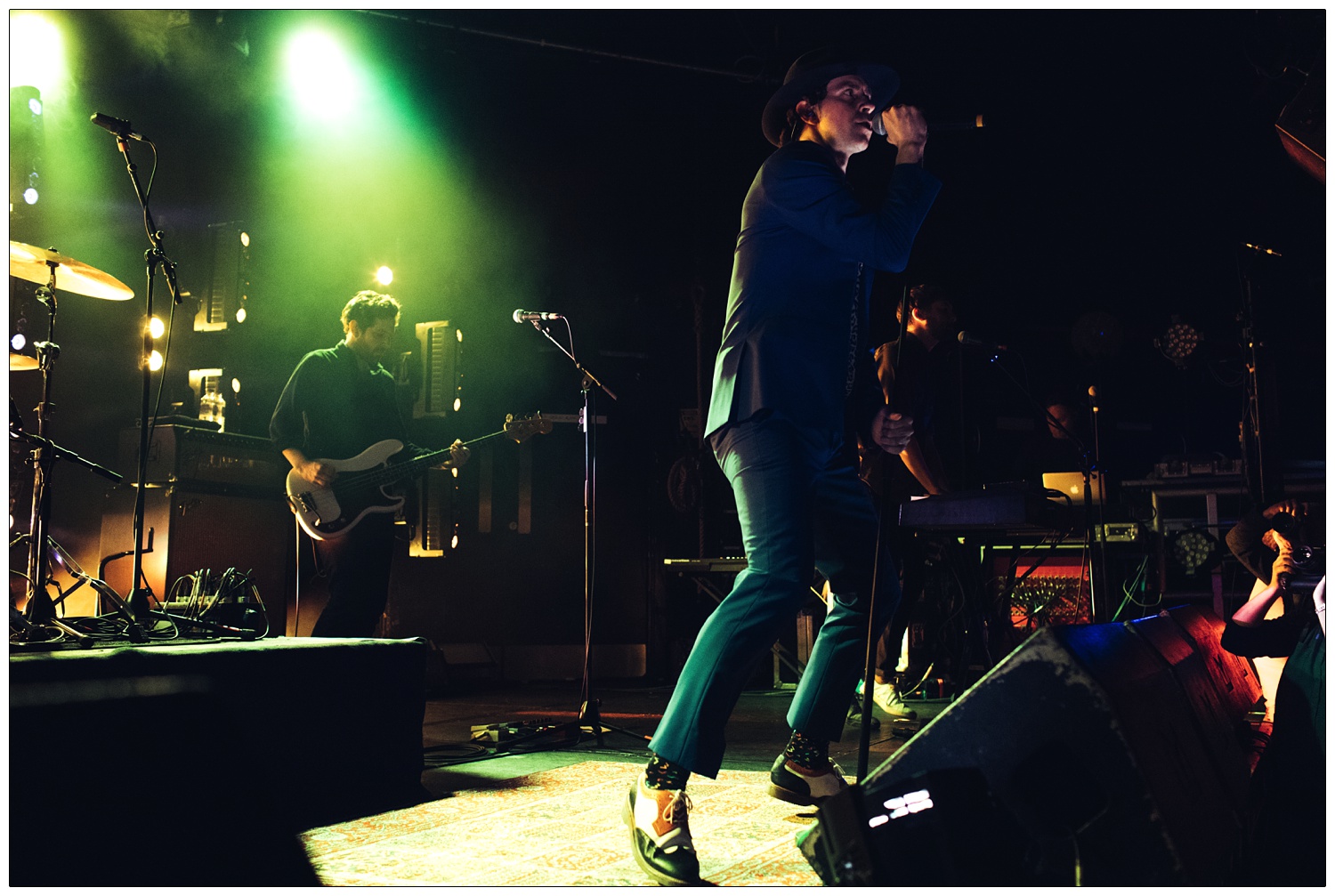 Paul Smith in a suit singing on stage with Paul Rafferty on bass and Lukas Wooller on keyboard at Cambridge Junction Maxïmo park gig in 2017