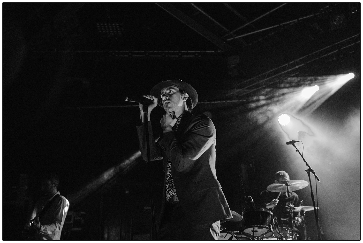 Paul Smith hushing lips with finger whilst performing at the Cambridge Junction with Maxïmo Park