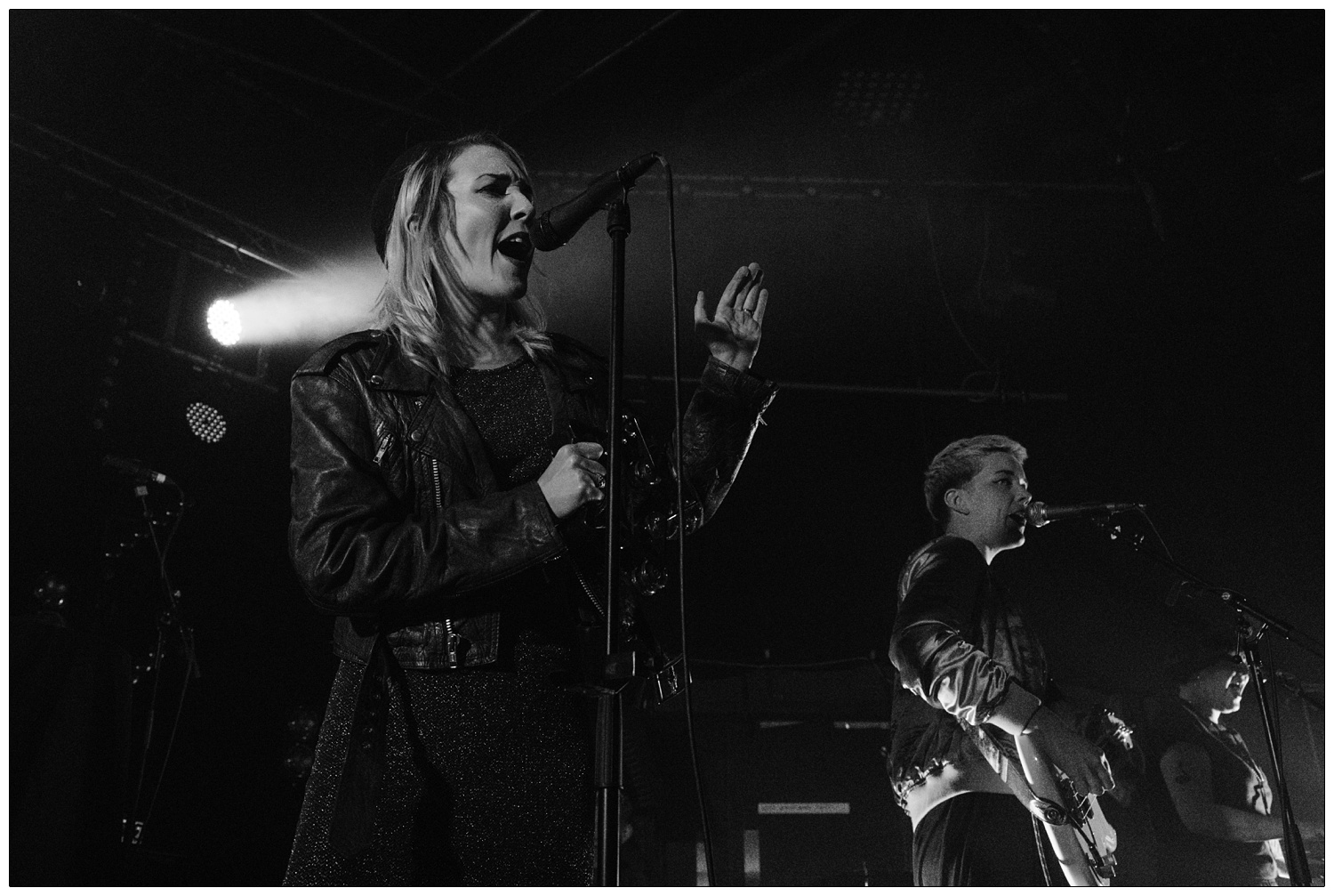 Faith Vern singing on stage with band PINS supporting Maxïmo Park