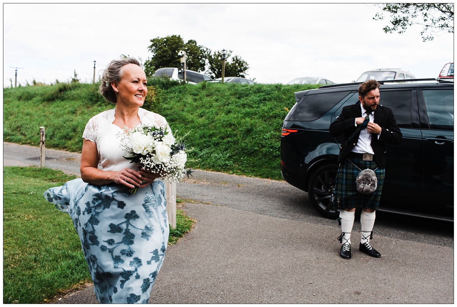 Bride standing outside in the wind before the wedding.